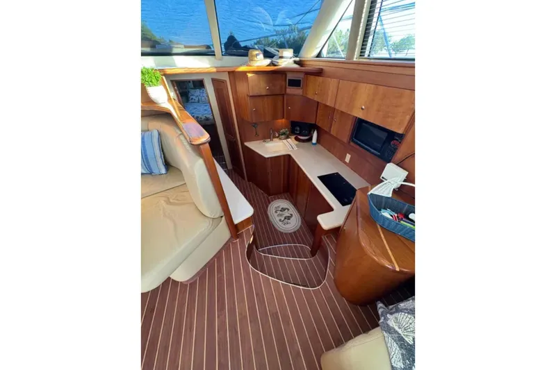  Yacht Photos Pics Interior of 2003 Silverton 42 Convertible yacht with modern kitchen and seating area.