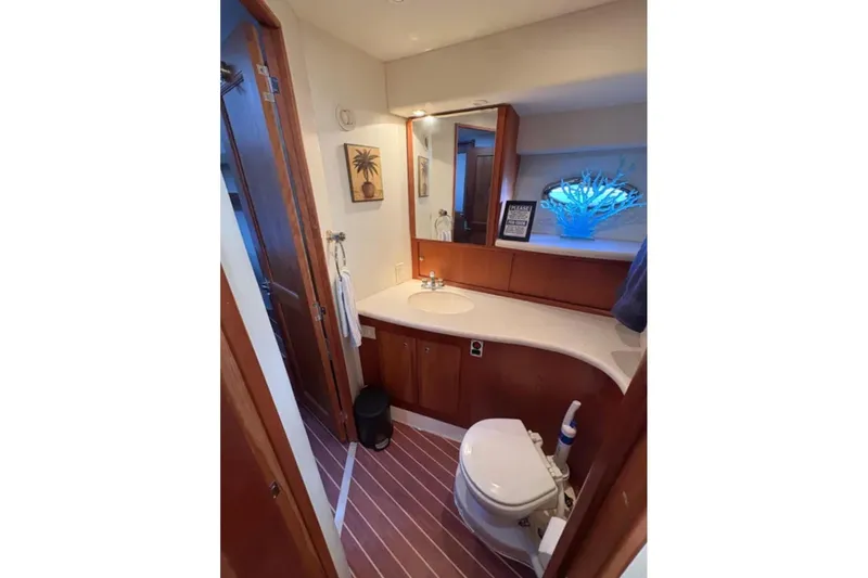 Yacht Photos Pics Bathroom interior of 2003 Silverton 42 Convertible yacht, featuring modern amenities and wooden accents.