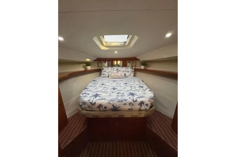  Yacht Photos Pics Luxurious cabin interior of 2003 Silverton 42 Convertible yacht with skylight and tropical bedding.