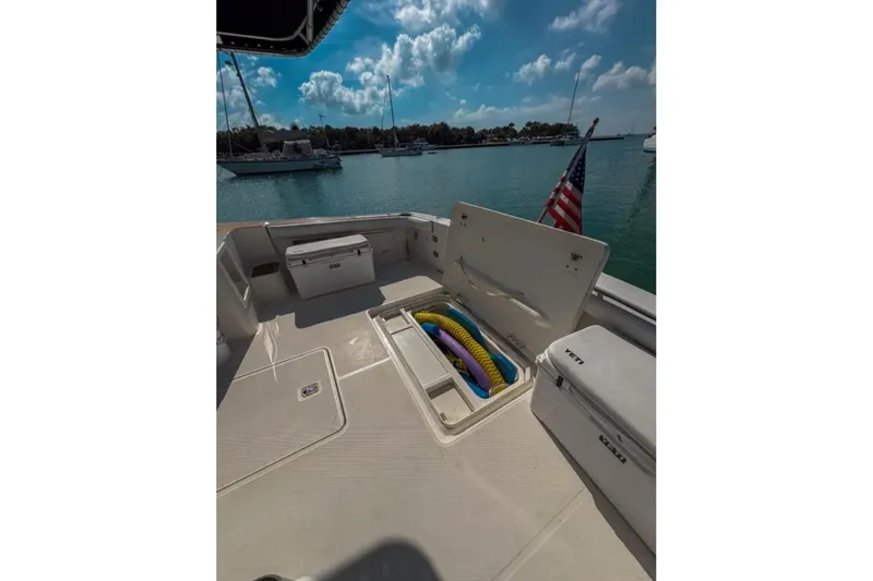  Yacht Photos Pics 2003 Silverton 42 Convertible boat deck with storage compartments and American flag.