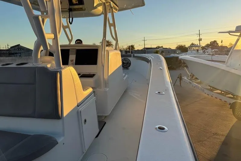  Yacht Photos Pics 2015 Yellowfin 39 Offshore boat interior at sunset, showcasing helm and seating area.