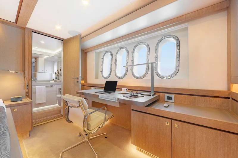  Yacht Photos Pics Luxurious Van der Valk HELGA 2021 yacht interior with modern office space and porthole windows.