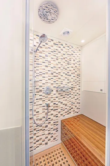  Yacht Photos Pics Modern shower with mosaic tiles and wooden flooring in Van der Valk HELGA 2021 model.