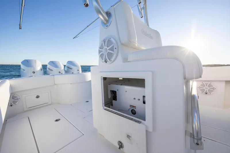  Yacht Photos Pics 2024 Onslow Bay 33 TE boat interior with open storage, speakers, and triple Mercury engines.