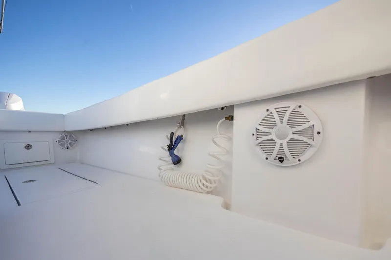  Yacht Photos Pics 2024 Onslow Bay 33 TE boat interior with speakers and coiled hose against blue sky.