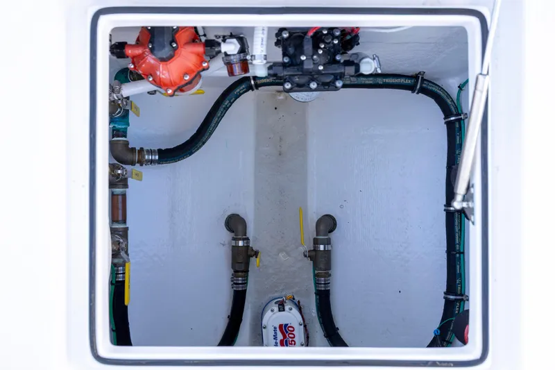  Yacht Photos Pics 2024 Onslow Bay 33 TE boat compartment with visible plumbing and mechanical components.