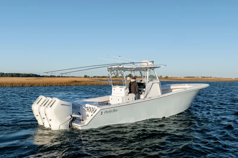  Yacht Photos Pics 2024 Onslow Bay 33 TE boat with triple Mercury engines on open water.