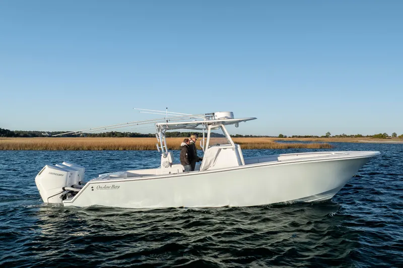  Yacht Photos Pics 2024 Onslow Bay 33 TE boat cruising on calm waters under clear blue sky.