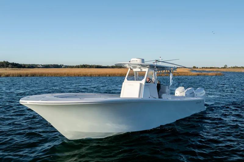  Yacht Photos Pics 2024 Onslow Bay 33 TE boat cruising on a calm lake under clear skies.