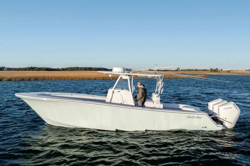  Yacht Photos Pics 2024 Onslow Bay 33 TE boat cruising on a calm lake with clear blue skies.