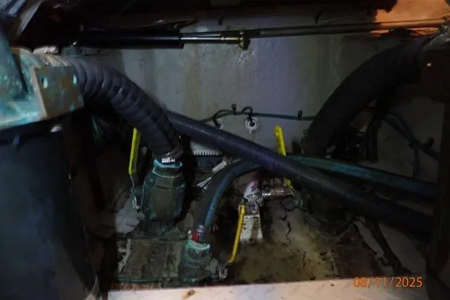  Yacht Photos Pics Engine room of a 2003 Sea Ray 460 Sundancer with visible hoses and machinery.