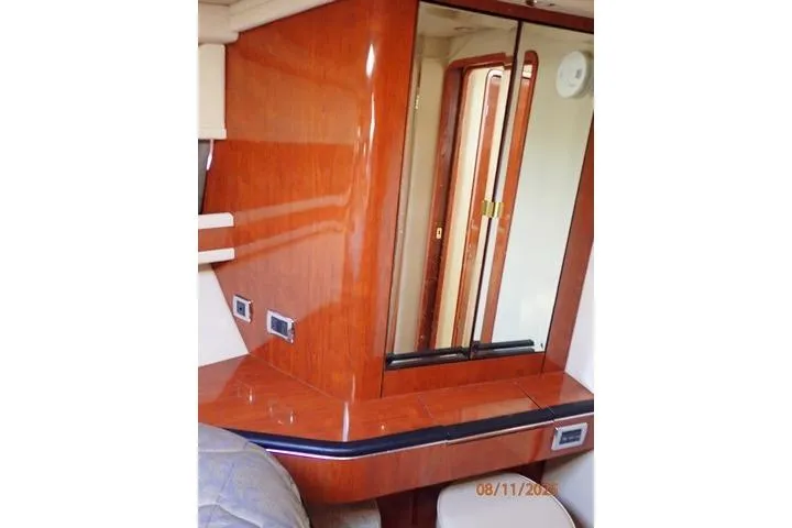  Yacht Photos Pics 2003 Sea Ray 460 Sundancer cabin interior with wood finish and mirrored cabinet.