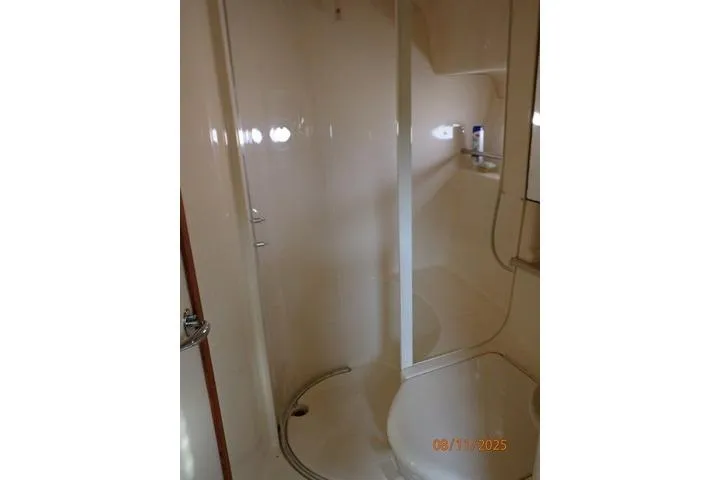  Yacht Photos Pics Bathroom interior of 2003 Sea Ray 460 Sundancer yacht, featuring a compact shower.