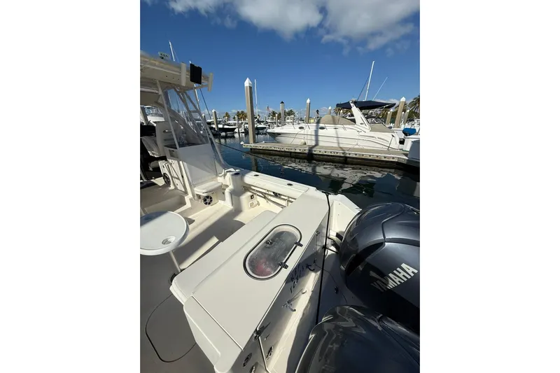  Yacht Photos Pics 2004 Pursuit 3370 Offshore boat docked with Yamaha engines, clear sky background.