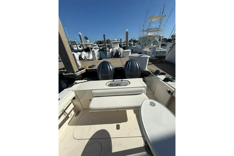  Yacht Photos Pics 2004 Pursuit 3370 Offshore boat docked at marina, featuring dual engines and spacious deck.