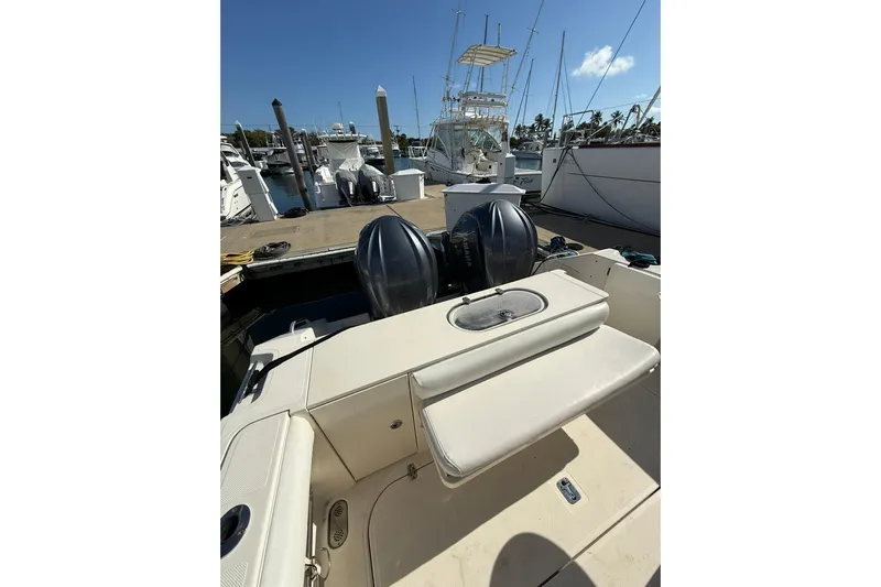  Yacht Photos Pics 2004 Pursuit 3370 Offshore boat docked with dual engines, sunny marina background.