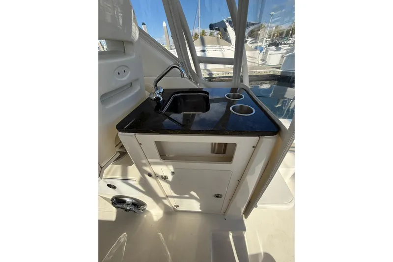  Yacht Photos Pics 2004 Pursuit 3370 Offshore boat interior with sink and cup holders.