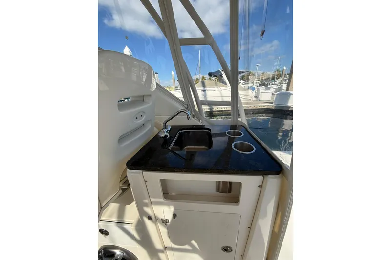  Yacht Photos Pics 2004 Pursuit 3370 Offshore boat interior with sink and cup holders.