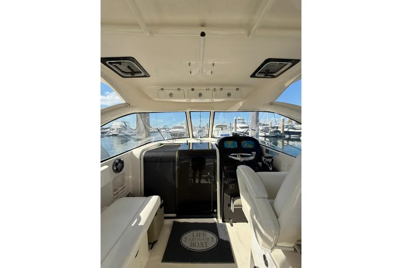  Yacht Photos Pics 2004 Pursuit 3370 Offshore boat interior with helm, seating, and marina view.