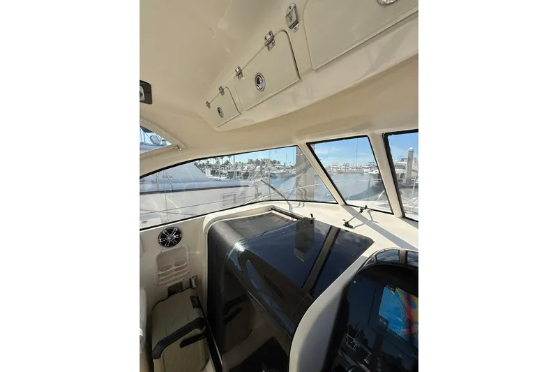  Yacht Photos Pics 2004 Pursuit 3370 Offshore boat interior with marina view through windows.