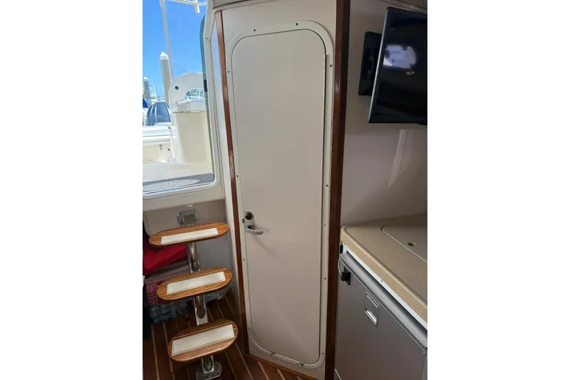  Yacht Photos Pics Interior of 2004 Pursuit 3370 Offshore boat with steps and cabin door.