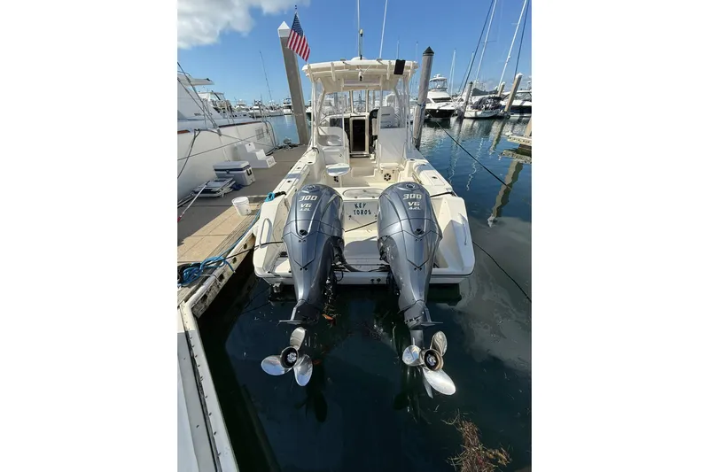  Yacht Photos Pics 2004 Pursuit 3370 Offshore boat with twin 300 V6 engines docked at marina.