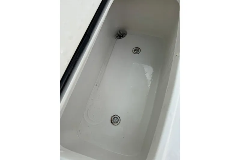  Yacht Photos Pics Livewell compartment in a 2014 Jupiter 34 boat, featuring drainage outlets.