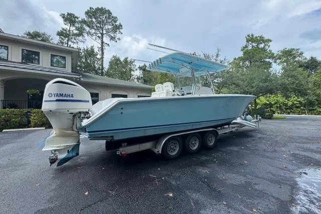  Yacht Photos Pics 2014 Jupiter 34 boat with Yamaha engine on a trailer, parked outdoors.