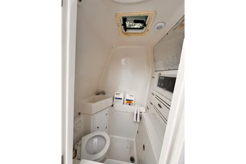  Yacht Photos Pics Compact bathroom in 2014 Jupiter 34 boat, featuring toilet, sink, and storage.
