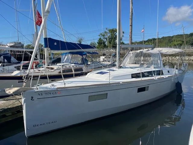 Nansea I Yacht Photos Pics 2017 Beneteau Oceanis 38.1 sailboat docked in a marina under clear blue skies.