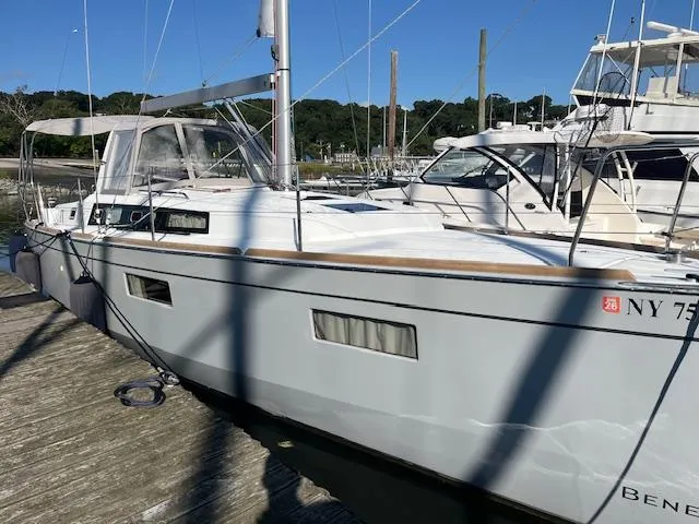 Nansea I Yacht Photos Pics 2017 Beneteau Oceanis 38.1 sailboat docked at a marina, side view.
