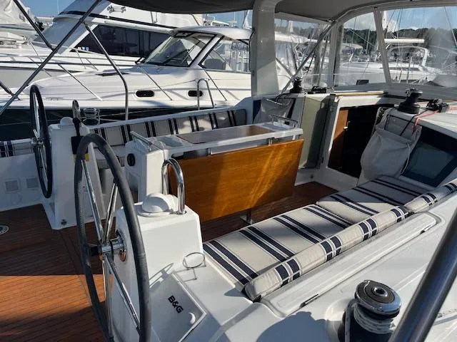 Nansea I Yacht Photos Pics 2017 Beneteau Oceanis 38.1 yacht cockpit with dual steering wheels and striped seating.