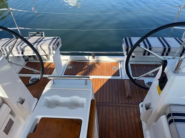 Nansea I Yacht Photos Pics Cockpit of 2017 Beneteau Oceanis 38.1 sailboat with dual steering wheels and striped seating.
