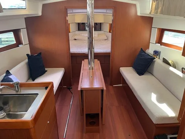 Nansea I Yacht Photos Pics Interior of 2017 Beneteau Oceanis 38.1 sailboat with cozy seating and wood finish.