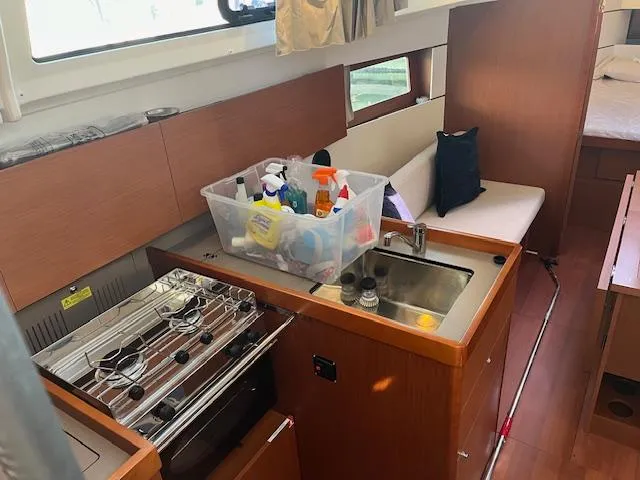 Nansea I Yacht Photos Pics Interior of 2017 Beneteau Oceanis 38.1 yacht with kitchen and seating area.