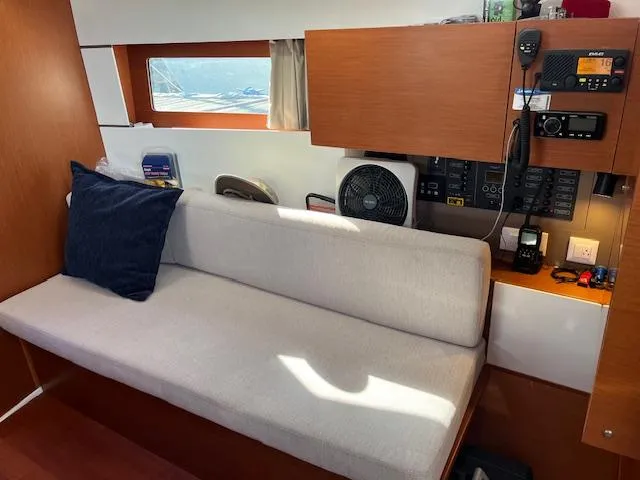 Nansea I Yacht Photos Pics Interior of 2017 Beneteau Oceanis 38.1 yacht with beige sofa and navigation equipment.