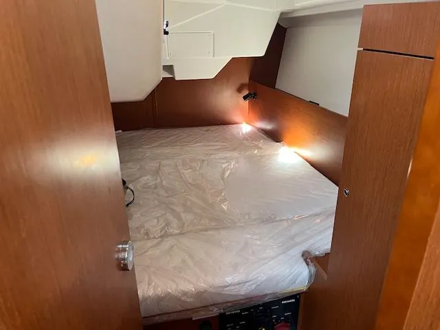 Nansea I Yacht Photos Pics Cabin interior of 2017 Beneteau Oceanis 38.1 sailboat with cozy bed setup.