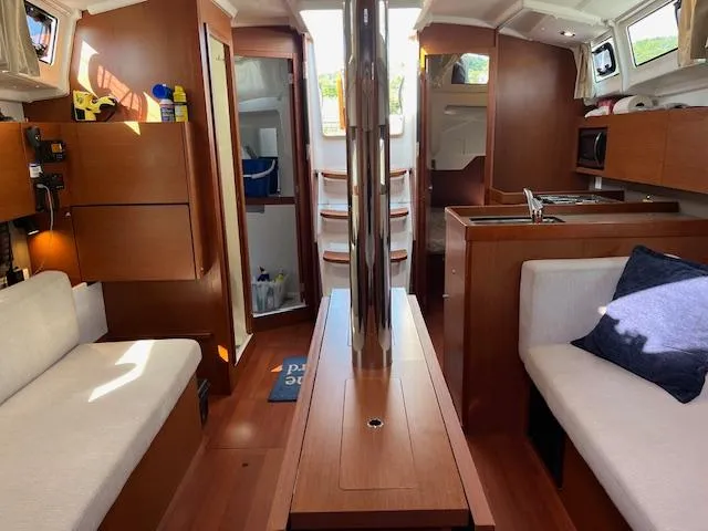 Nansea I Yacht Photos Pics Interior of 2017 Beneteau Oceanis 38.1 sailboat with wood finish and cozy seating.