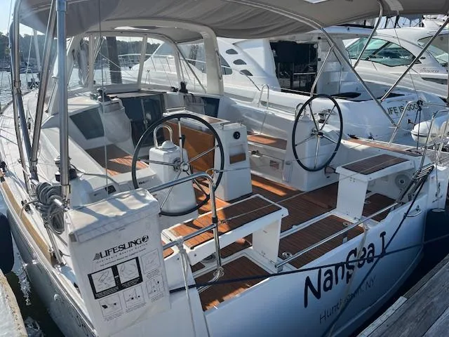 Nansea I Yacht Photos Pics 2017 Beneteau Oceanis 38.1 sailboat with dual steering wheels and teak deck in marina.