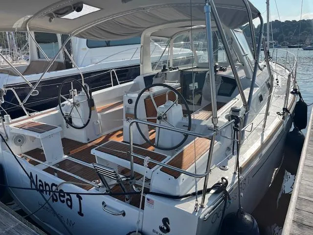 Nansea I Yacht Photos Pics 2017 Beneteau Oceanis 38.1 sailboat docked, featuring dual steering wheels and teak decking.