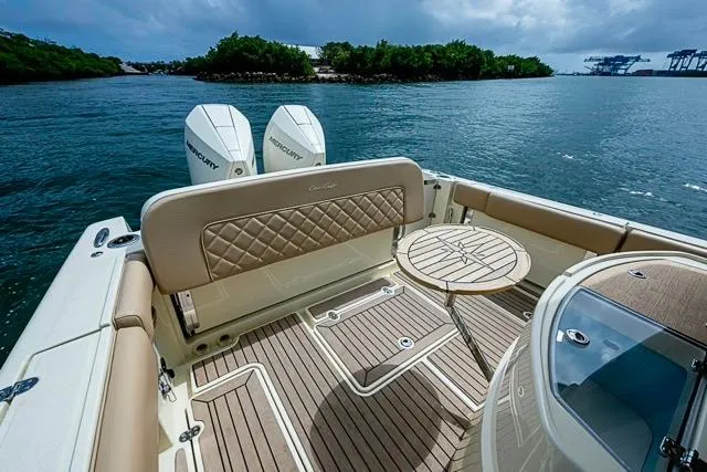  Yacht Photos Pics 2019 Chris-Craft Catalina 30 boat interior with twin Mercury engines, docked near lush shoreline.