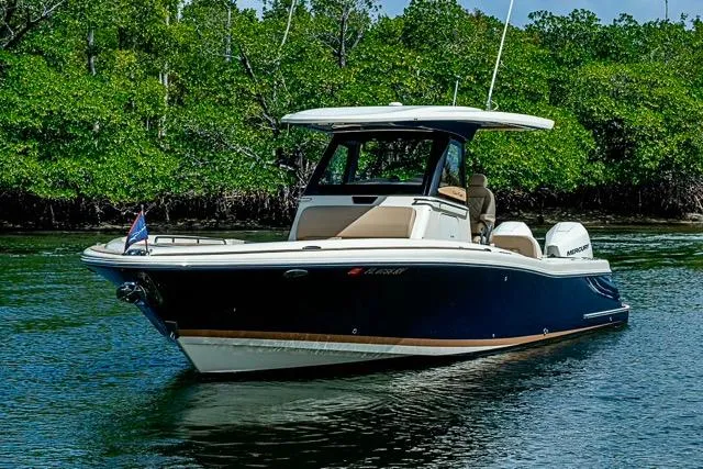  Yacht Photos Pics 2019 Chris-Craft Catalina 30 boat cruising on a serene waterway with lush greenery.