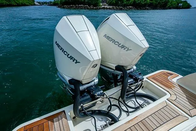  Yacht Photos Pics Twin Mercury outboard engines on a 2019 Chris-Craft Catalina 30, docked on clear water.