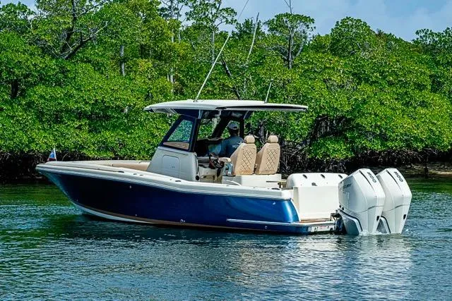  Yacht Photos Pics 2019 Chris-Craft Catalina 30 boat cruising near lush green mangroves.