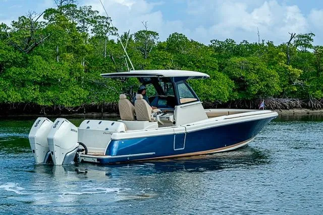  Yacht Photos Pics 2019 Chris-Craft Catalina 30 boat cruising near lush green mangroves.