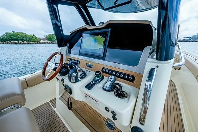  Yacht Photos Pics 2019 Chris-Craft Catalina 30 helm with modern navigation system and wooden accents.