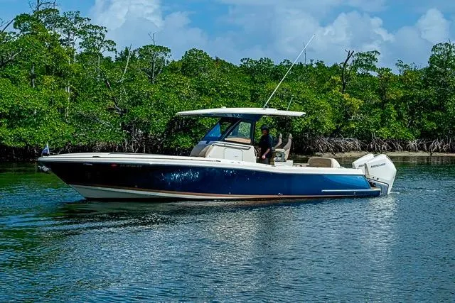  Yacht Photos Pics 2019 Chris-Craft Catalina 30 boat cruising on a calm river with lush greenery.