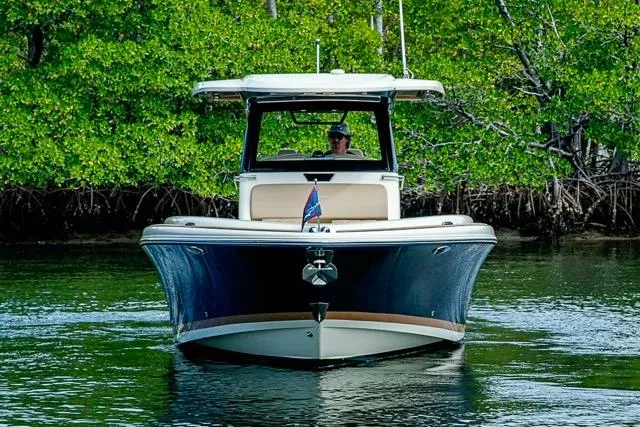  Yacht Photos Pics 2019 Chris-Craft Catalina 30 boat cruising in lush, green waters.