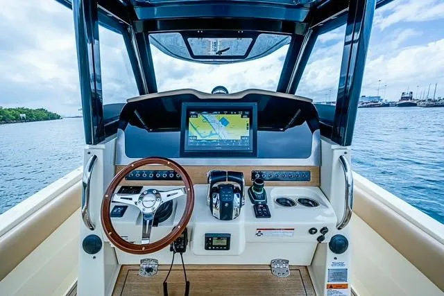  Yacht Photos Pics 2019 Chris-Craft Catalina 30 helm with navigation display and steering wheel, overlooking the ocean.