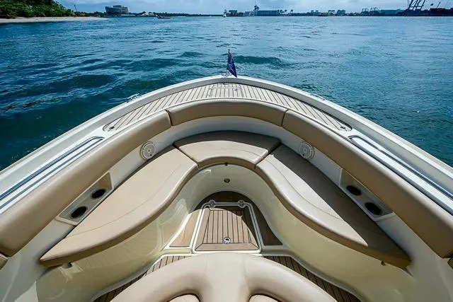  Yacht Photos Pics 2019 Chris-Craft Catalina 30 boat interior with tan seating, on calm water.